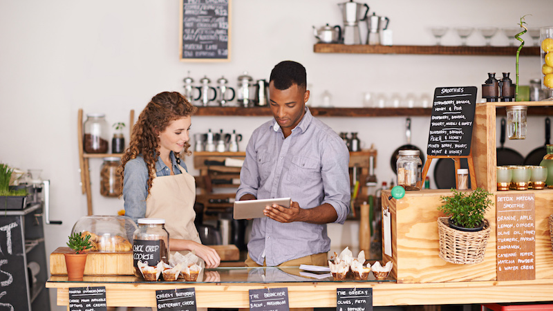 business owner showing tablet to employee