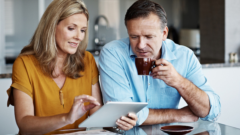 wife showing tablet to her husband