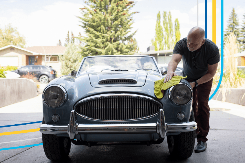 image of a man polishing his collector car in his garage