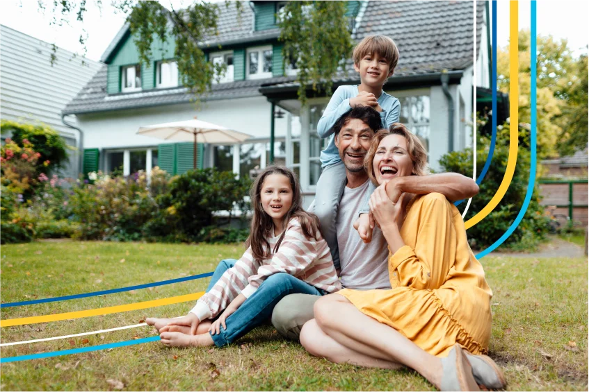 Family sitting outside their home covered by home insurance
