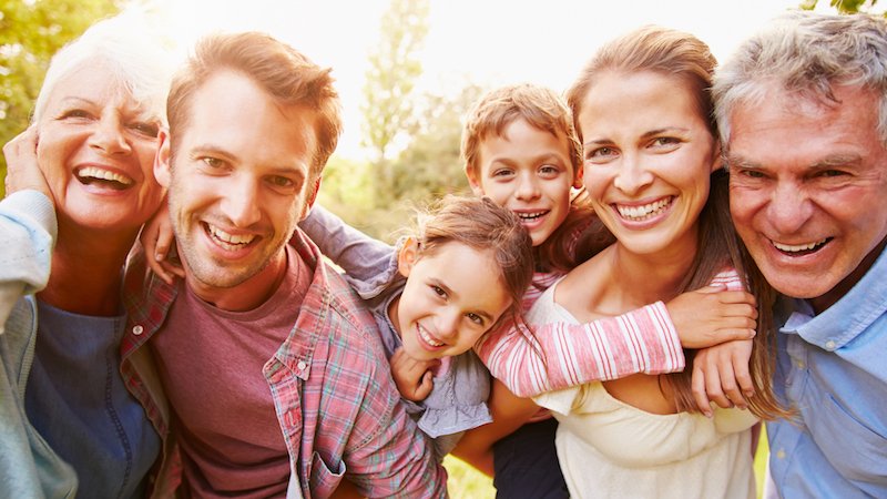 a family of six smiling at camera