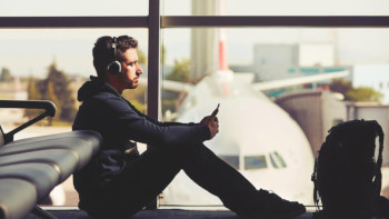 male passenger waiting to board airplane